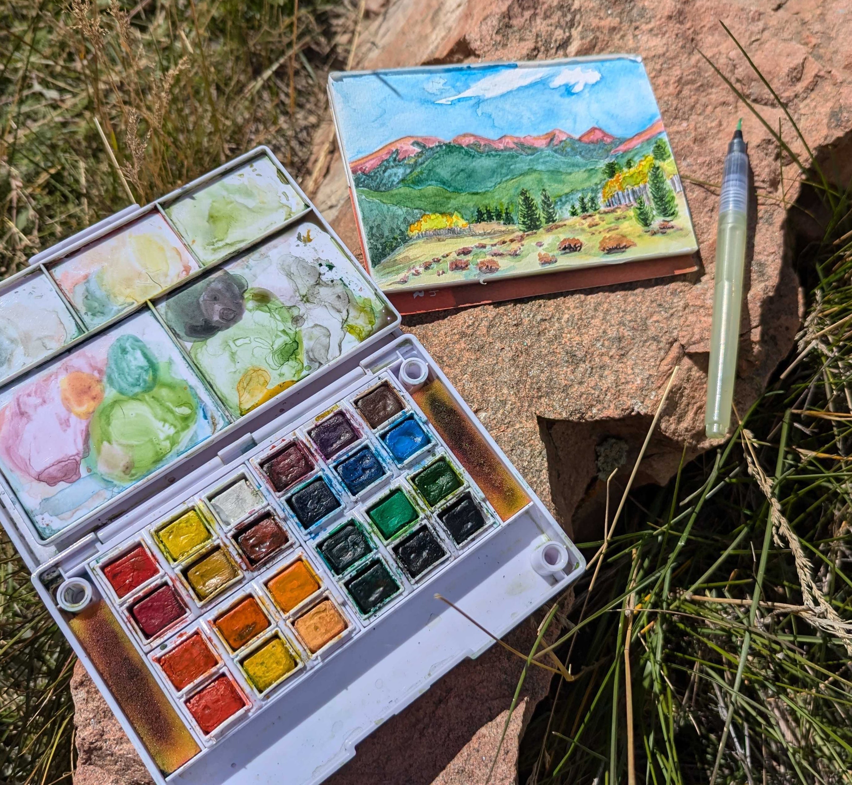 Image of a small field study at Kenosha pass and a mini watercolor kit. 